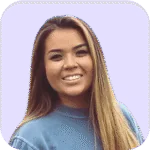 A woman with long, straight, light brown hair, wearing a blue top, smiles at the camera against a light purple background.