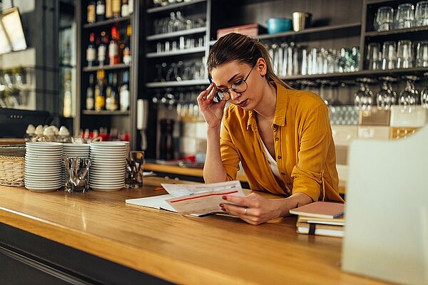 Mujer revisando las facturas de los restaurantes