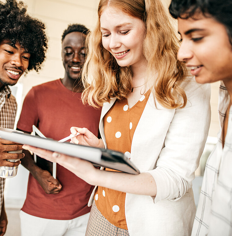 Young people looking at a tablet device