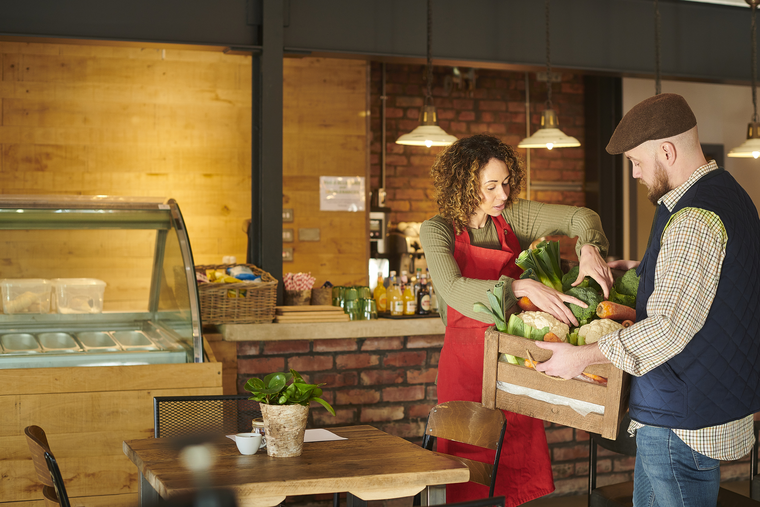 woman taking vegetable stocks at restaurant