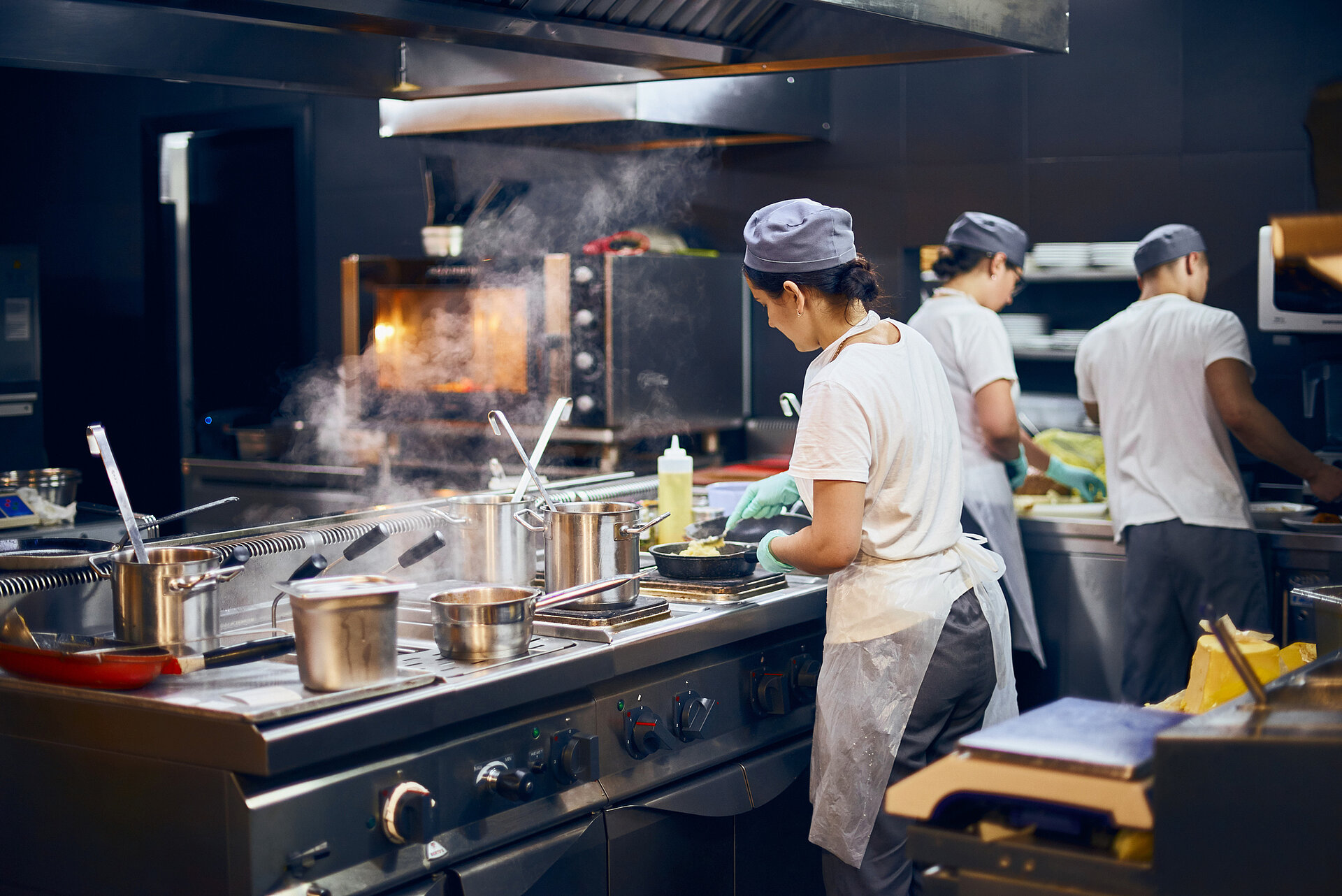 Woman working in a busy kitchen