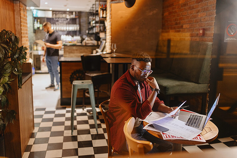 Restaurant manager calculating restaurant costs