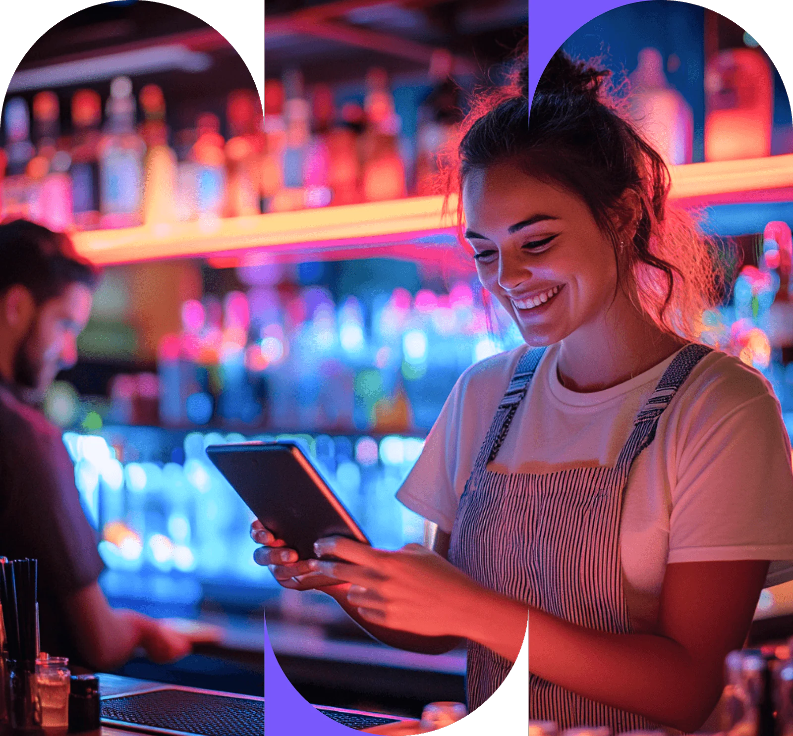 En smilende bartender i forkle bruker et nettbrett i en lys bar med fargerike flasker og neonlys, mens en annen person jobber i bakgrunnen.
