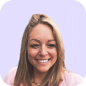 A woman with straight blonde hair smiles at the camera. She is wearing a light pink top, and the background is a solid light purple colour with rounded corners.