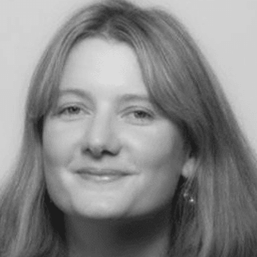 Black and white portrait of a woman with long, straight hair, smiling softly at the camera against a plain background.