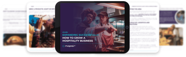 A tablet displays a guide titled Expanding Successfully: How to Grow a Hospitality Business with two people in a restaurant setting; blurred documents are in the background.